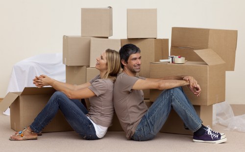 Professional movers carrying furniture through a Westminster apartment building