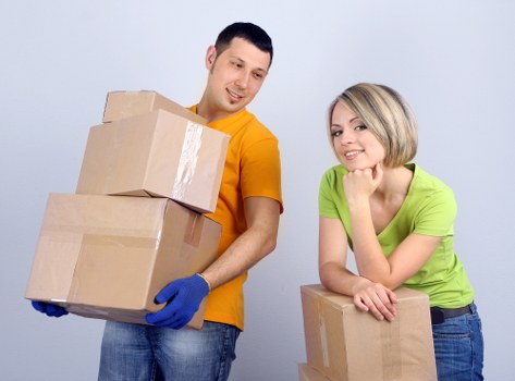 Removal workers carrying furniture through a central London building