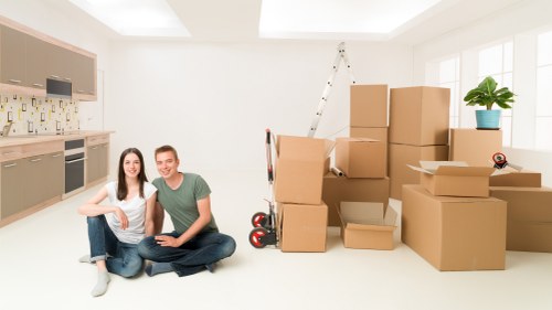 Professional movers carrying furniture during a Westminster house move