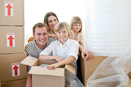 Moving boxes and furniture being loaded into a van