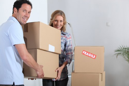 Movers carrying furniture through a Westminster apartment building corridor